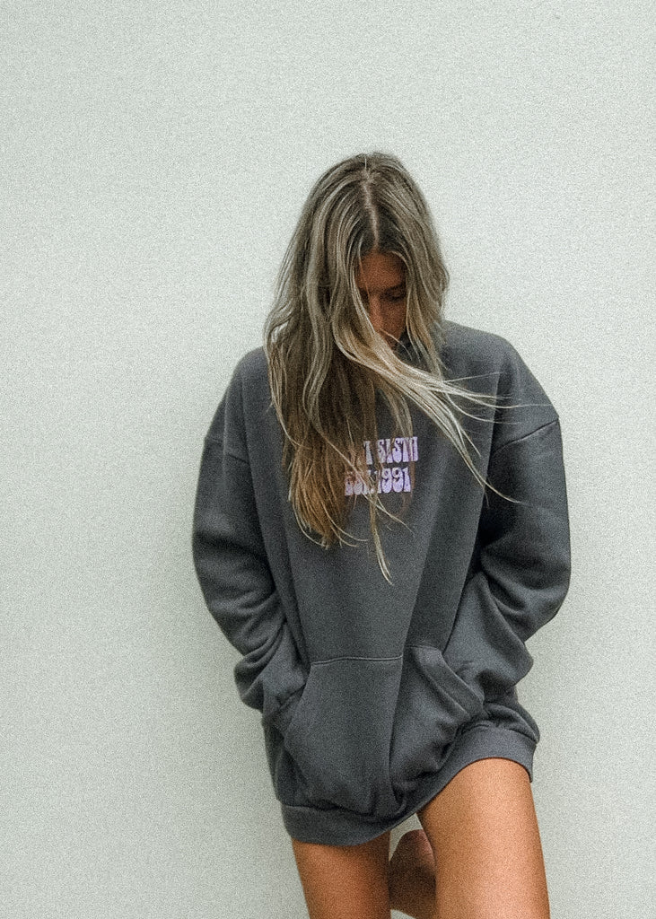 Person wearing a gray hoodie with text on a light gray background